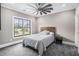 This cozy bedroom boasts a ceiling fan and a large window, offering a comfortable and well-lit space at 3039 Malbec Vly, Acworth, GA 30101