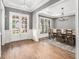 Dining room features a large dining table, hardwood floors, large windows, and wainscotting at 3039 Malbec Vly, Acworth, GA 30101