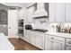 Bright kitchen with white cabinets, stainless steel appliances, gas range, and decorative tile backsplash at 3039 Malbec Vly, Acworth, GA 30101
