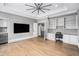 Large living room with hardwood floors, built-in shelves, and a ceiling fan at 3039 Malbec Vly, Acworth, GA 30101