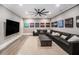 Spacious living room with black sectional sofa, large TV, and carpet at 3039 Malbec Vly, Acworth, GA 30101