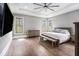 Spacious main bedroom with hardwood floors, tray ceiling, ample natural light, and comfortable furniture at 3039 Malbec Vly, Acworth, GA 30101