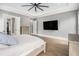 Large primary bedroom featuring a king bed, ceiling fan, and an adjoining ensuite bathroom and closet at 3039 Malbec Vly, Acworth, GA 30101