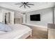 Bright main bedroom boasts a large TV, hardwood floors, and access to a walk-in closet at 3039 Malbec Vly, Acworth, GA 30101