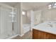 Bathroom showcasing a glass shower, soaking tub, and double sink vanity at 679 Barley Hill Ln, Sugar Hill, GA 30518