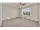 Spacious bedroom with neutral carpet, ceiling fan, and window for natural light at 679 Barley Hill Ln, Sugar Hill, GA 30518