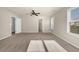 Large bedroom with a ceiling fan and natural light shining through the window at 679 Barley Hill Ln, Sugar Hill, GA 30518