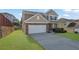 Charming two-story home with stone accents, well-manicured lawn, and a two car garage at 679 Barley Hill Ln, Sugar Hill, GA 30518