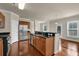 Modern kitchen with stainless steel appliances, granite countertops, and an island with a sink at 679 Barley Hill Ln, Sugar Hill, GA 30518