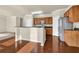 Spacious kitchen featuring stainless steel appliances, wood cabinets, and a breakfast bar at 679 Barley Hill Ln, Sugar Hill, GA 30518