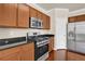 Features stainless steel appliances, granite countertops, and cherry cabinets at 679 Barley Hill Ln, Sugar Hill, GA 30518
