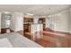 Open-concept kitchen with stainless steel appliances, wooden cabinets, and breakfast bar at 679 Barley Hill Ln, Sugar Hill, GA 30518