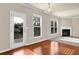 Bright living area with a patio door to the backyard, fireplace and hardwood floors at 679 Barley Hill Ln, Sugar Hill, GA 30518