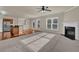 Open-concept living room with fireplace, neutral colors, and seamless flow to kitchen at 679 Barley Hill Ln, Sugar Hill, GA 30518