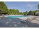 Community pool surrounded by lounge chairs, providing a perfect spot for relaxation and recreation in the sun at 679 Barley Hill Ln, Sugar Hill, GA 30518