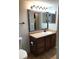 Well-lit bathroom vanity with framed mirror and modern fixtures at 812 Seasons Pkwy, Norcross, GA 30093