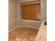 Dining area with light-colored walls and a window with wood blinds at 812 Seasons Pkwy, Norcross, GA 30093