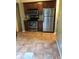 Charming kitchen featuring stainless steel appliances, ample cabinet space, and tile flooring at 812 Seasons Pkwy, Norcross, GA 30093