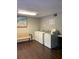 Clean laundry room with modern washers, a comfortable bench, and ample lighting at 812 Seasons Pkwy, Norcross, GA 30093