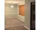Cozy living room with neutral carpet and sliding glass doors to a screened-in porch at 812 Seasons Pkwy, Norcross, GA 30093