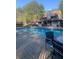 Inviting community pool with lounge seating, mature trees, and a relaxing atmosphere at 812 Seasons Pkwy, Norcross, GA 30093