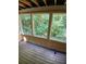 Cozy screened porch with wood flooring and view of the trees at 812 Seasons Pkwy, Norcross, GA 30093
