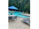 Community swimming pool with a table and chairs for relaxing by the pool at 812 Seasons Pkwy, Norcross, GA 30093
