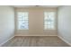 Bedroom featuring neutral walls, carpet and two windows that provide natural light at 2212 Butner Sw Rd, Atlanta, GA 30331