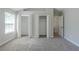 Bedroom featuring neutral walls, carpet, two closets and an entrance to another room at 2212 Butner Sw Rd, Atlanta, GA 30331
