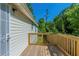 Side view of a wooden deck with a light-colored railing and a metal framed screen door with siding at 2212 Butner Sw Rd, Atlanta, GA 30331
