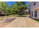 A grass covered backyard with mature trees and the side of the house at 498 Haven Ridge Dr, Stockbridge, GA 30281