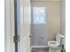 Powder room with white toilet and small window providing natural light at 498 Haven Ridge Dr, Stockbridge, GA 30281
