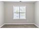 Bright bedroom featuring a large window, neutral walls, and cozy carpeting at 498 Haven Ridge Dr, Stockbridge, GA 30281
