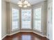 Bright dining room area with hardwood floors, bay window, and a modern light fixture at 498 Haven Ridge Dr, Stockbridge, GA 30281