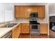 Functional kitchen with stainless steel appliances, wood cabinetry, and plenty of counter space at 498 Haven Ridge Dr, Stockbridge, GA 30281