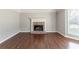 Spacious living room featuring hardwood flooring, a brick fireplace, and a view of the yard at 498 Haven Ridge Dr, Stockbridge, GA 30281