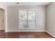 Bright living room featuring a large window with natural light and hardwood flooring at 498 Haven Ridge Dr, Stockbridge, GA 30281