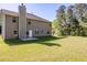 Exterior view of the home with a grassy lawn and mature trees at 5011 Wewatta Sw St, Atlanta, GA 30331
