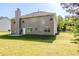 Backyard view of home with a patio and level, grassy lawn at 5011 Wewatta Sw St, Atlanta, GA 30331