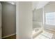 Bright bathroom showcasing a tiled tub and neutral paint at 5011 Wewatta Sw St, Atlanta, GA 30331