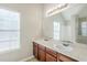 Bathroom featuring double sinks, a large mirror and bright natural light at 5011 Wewatta Sw St, Atlanta, GA 30331