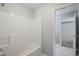 Bathroom featuring a tub with shower and white walls at 5011 Wewatta Sw St, Atlanta, GA 30331