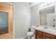 Powder room features wood vanity, sink, and standard toilet at 5011 Wewatta Sw St, Atlanta, GA 30331