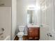 Functional bathroom featuring wood vanity, modern fixtures, and tile flooring at 5011 Wewatta Sw St, Atlanta, GA 30331