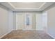 Neutral bedroom showcasing carpeted flooring and multiple entry and closet doors at 5011 Wewatta Sw St, Atlanta, GA 30331