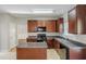 Bright kitchen offering dark wood cabinets, granite countertops and island at 5011 Wewatta Sw St, Atlanta, GA 30331