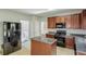 Open kitchen with a center island, granite countertops, dark appliances and cabinets at 5011 Wewatta Sw St, Atlanta, GA 30331