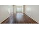 Inviting living room with hardwood floors and natural light streaming through a large window at 5011 Wewatta Sw St, Atlanta, GA 30331