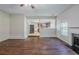 Open concept living room with hardwood floors and a fireplace at 5011 Wewatta Sw St, Atlanta, GA 30331