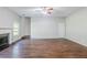Spacious living room featuring hardwood flooring, neutral walls, ceiling fan and fireplace at 5011 Wewatta Sw St, Atlanta, GA 30331